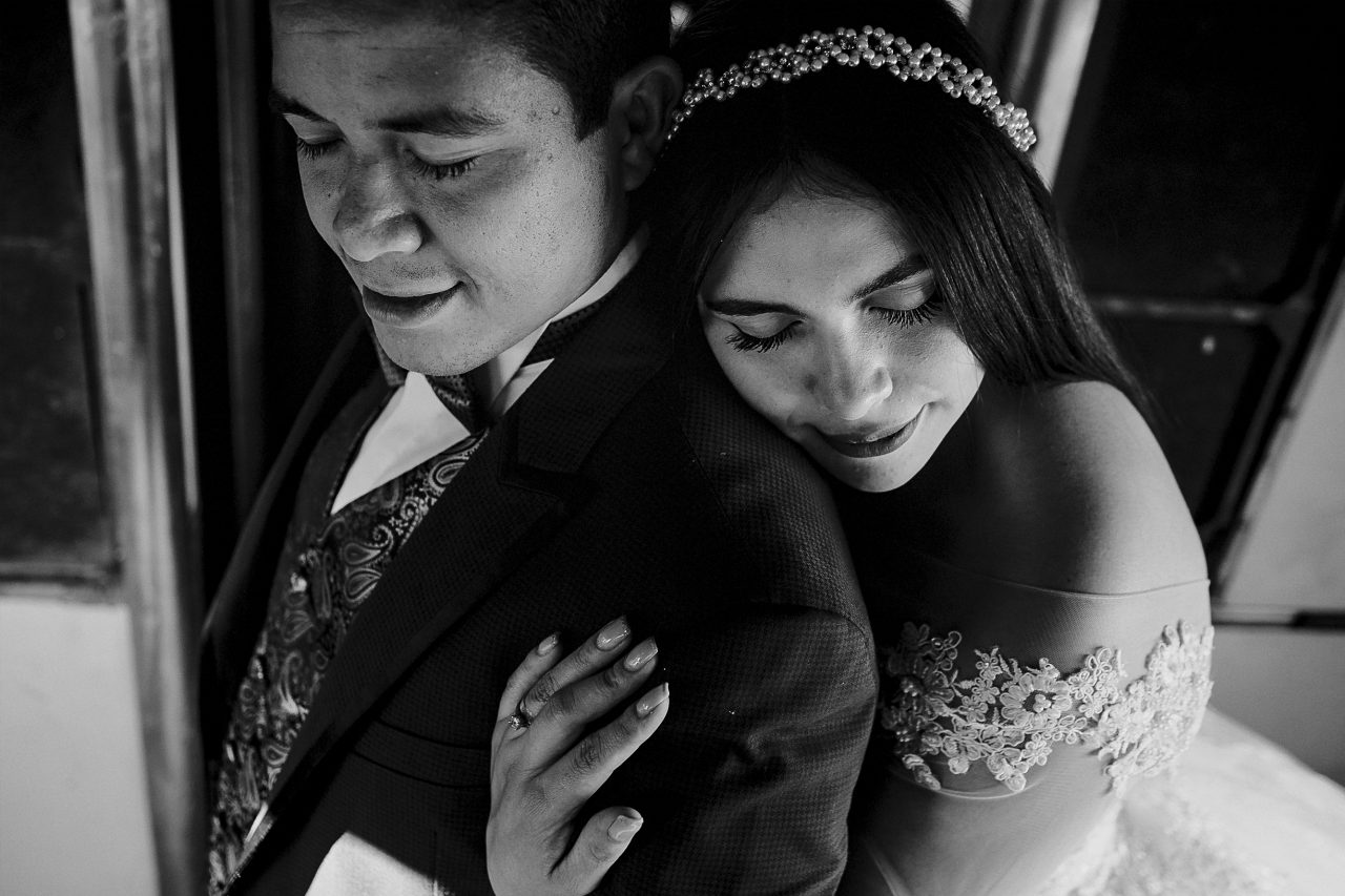 Couple embracing near a train at Tres Centurias Park in Aguascalientes Mexico showing contrast between industrial elements and human connection