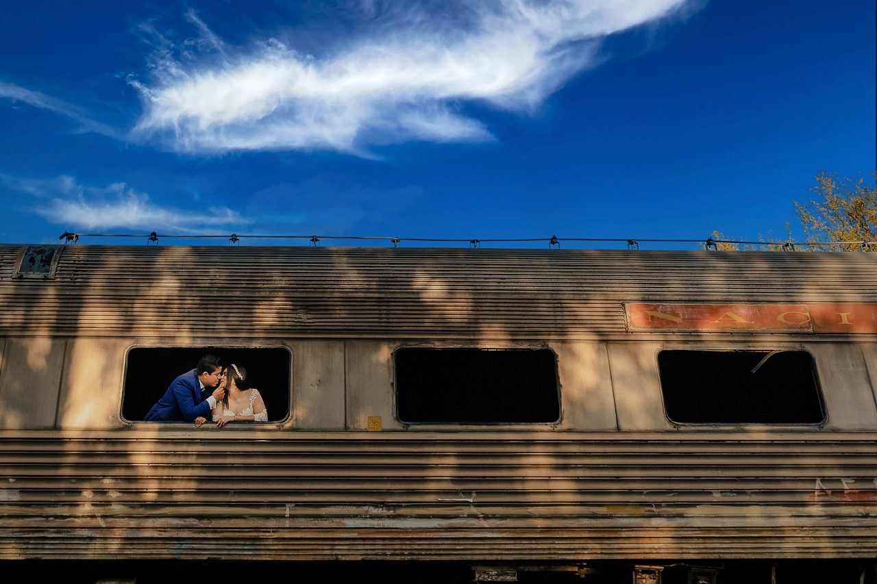 Couple framed by industrial structures at Tres Centurias Park in Aguascalientes Mexico with strong symmetry and composition