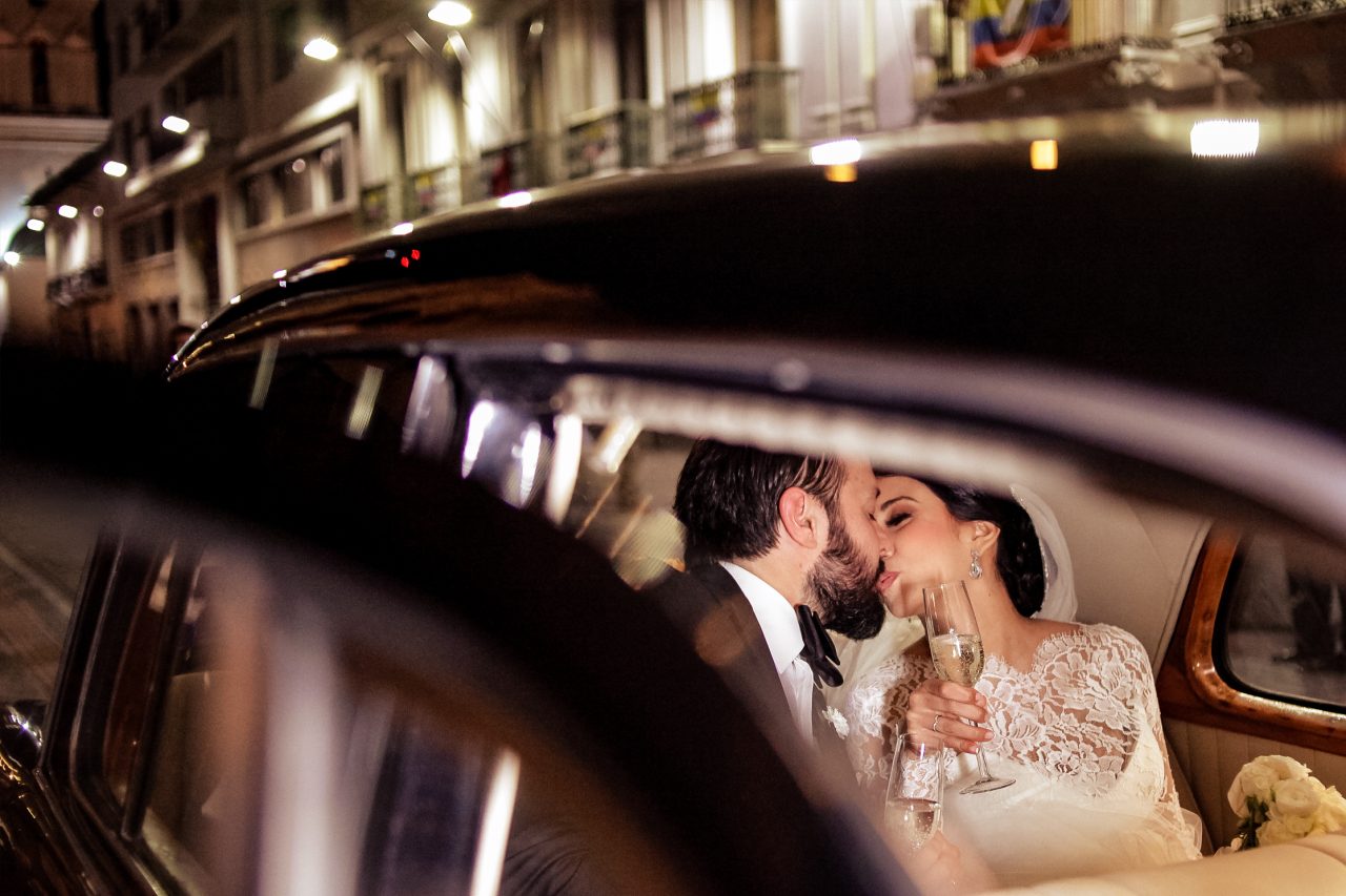 Couple inside a car at night in Quito Ecuador with city lights creating a cinematic wedding scene