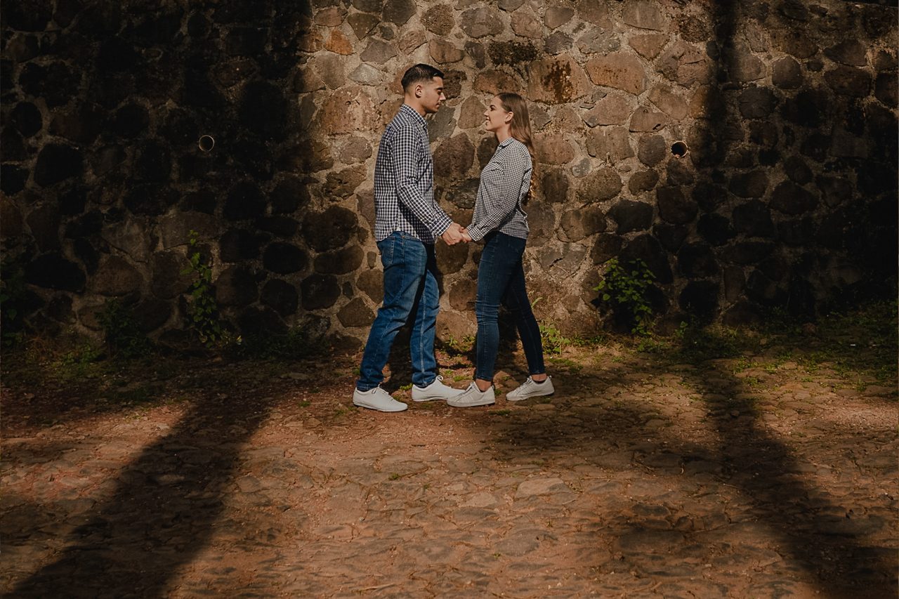 Couple walking together in a forest in Mazamitla Mexico during a pre wedding session with soft natural light