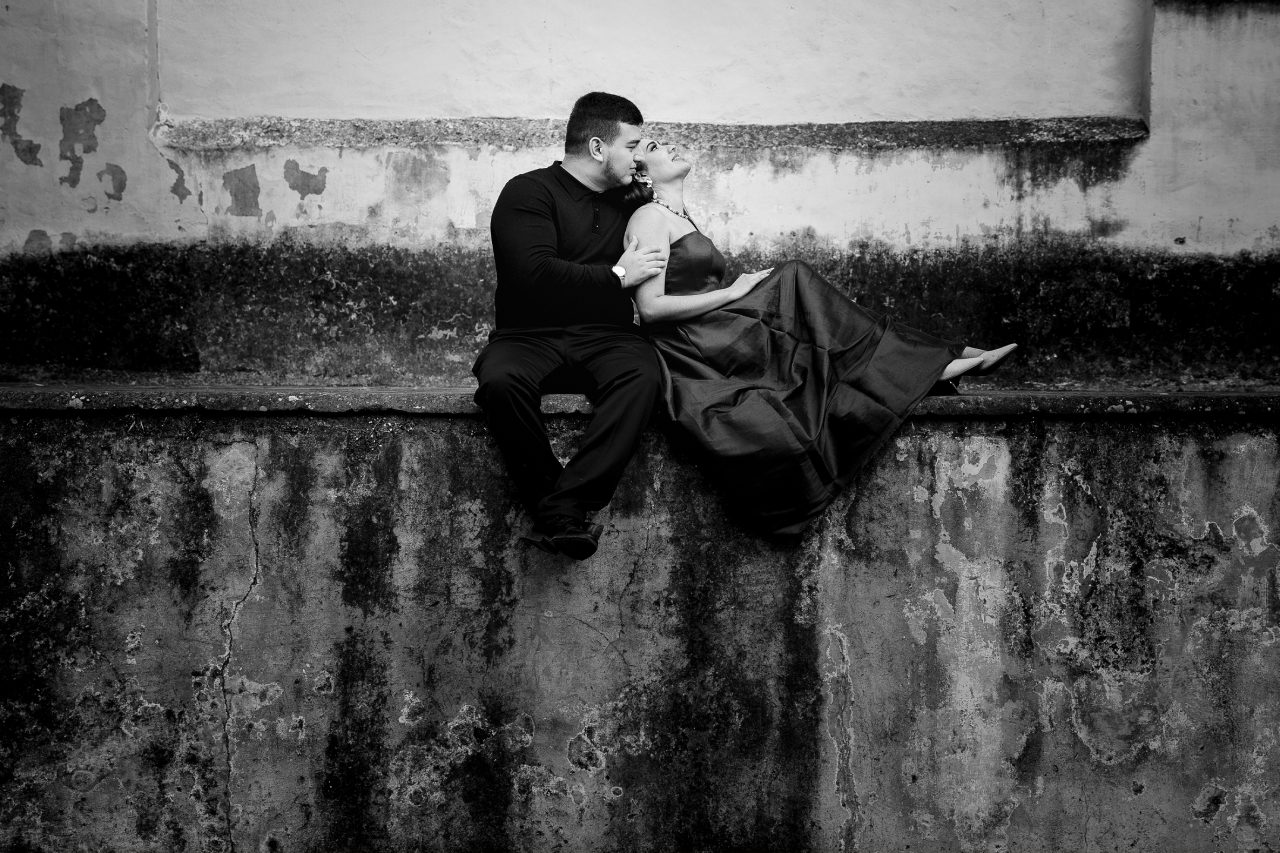 Romantic couple embracing at sunset under arches in Pátzcuaro Mexico during a destination wedding
