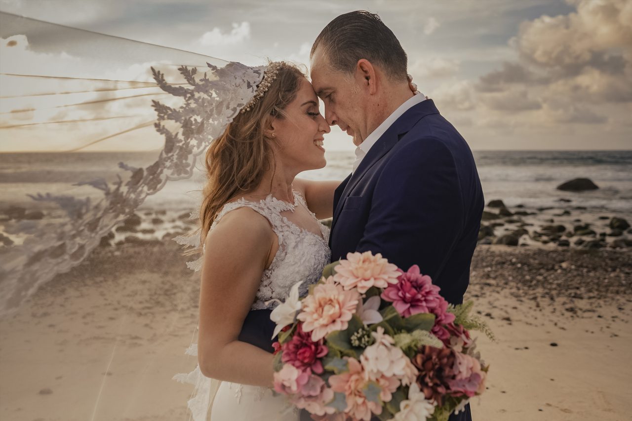 Elegant couple portrait on the beach in Mexico with cinematic light during a destination wedding session