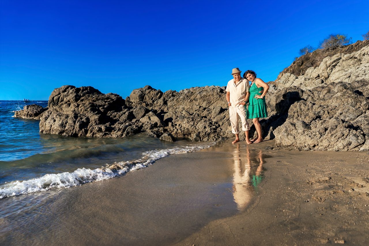 Editorial couple portrait at sunset in Sayulita Mexico using colored lighting and flash photography