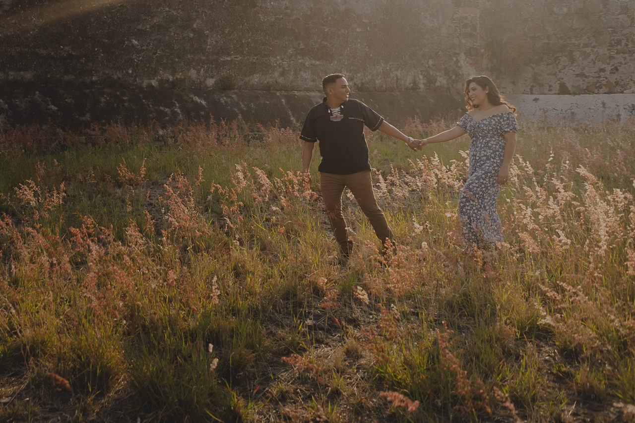 Couple walking together at Isla de Mezcala in Mexico during a pre-wedding session with natural light