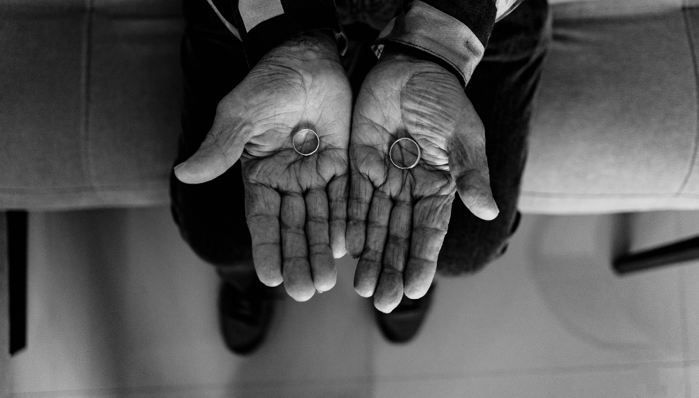 Father of the bride holding wedding rings in his hands black and white emotional moment